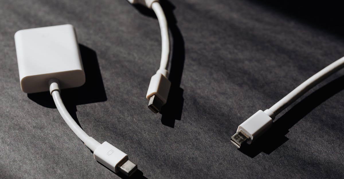 a collection of white usb and adapter cables on a textured dark background perfect for tech themes