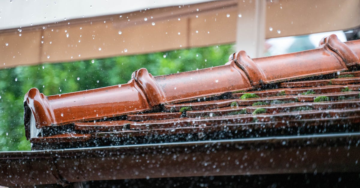 detailed view of rain droplets cascading off a terracotta roof capturing the essence of a rainy day