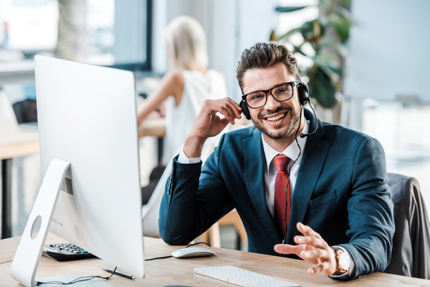 stock photo selective focus happy businessman headset gesturing while smiling office